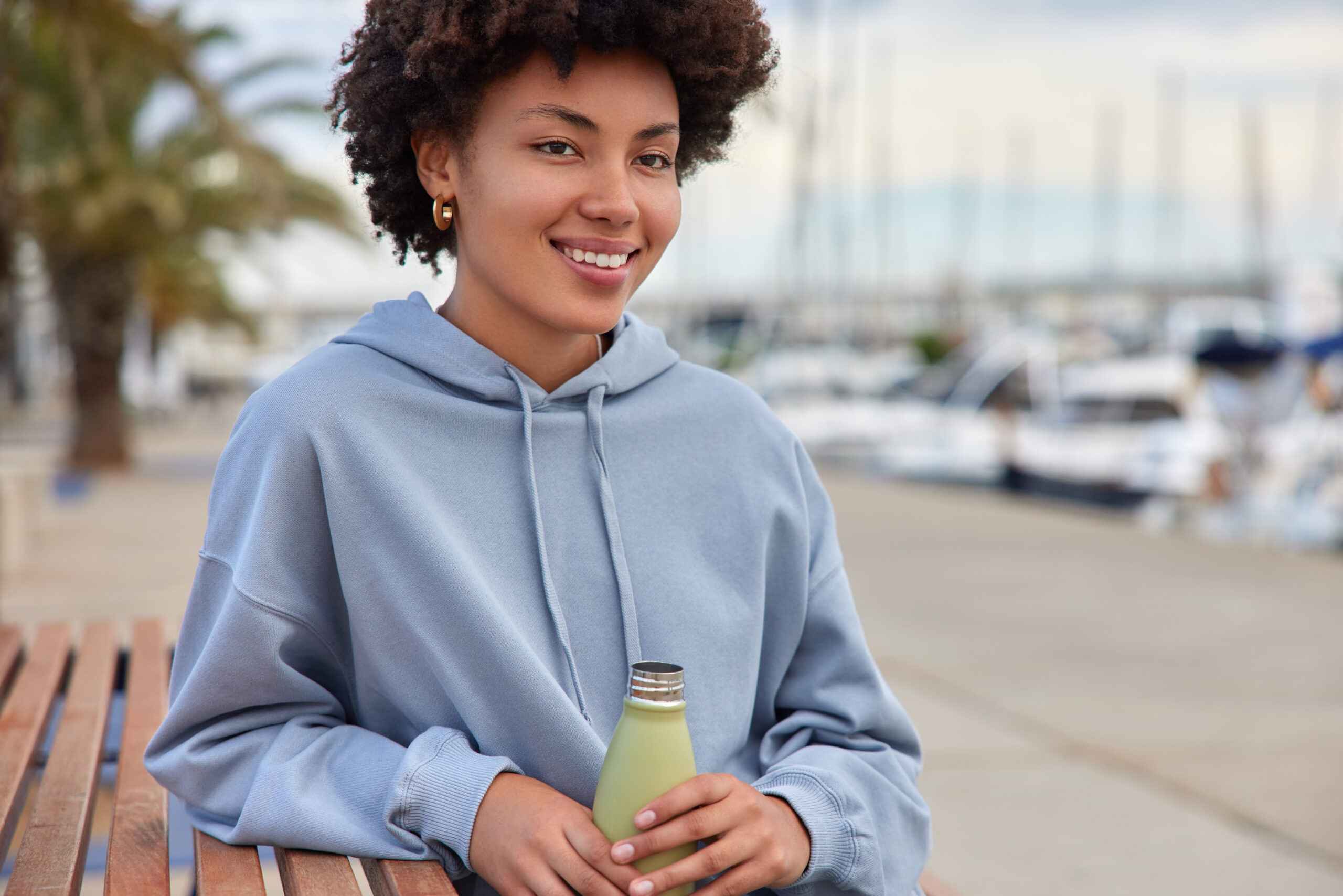 A woman feels good drinking water from a water bottle that she loves