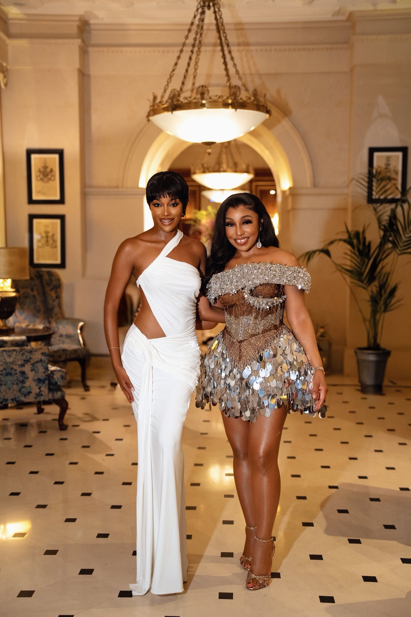 Beauty Tukura in white cut-out gown and Genevieve Nnaji in brown maxi-dress at Rita Dominic’s 50th birthday party.