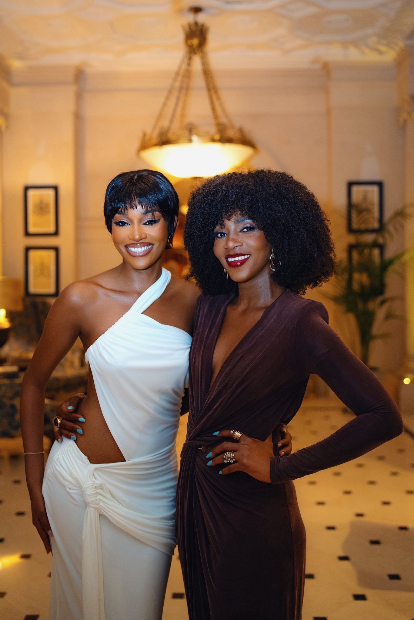Nigerian stars Beauty Tukura and Genevieve Nnaji twinning with similar hairstyles and makeup at Rita Dominic’s birthday event.