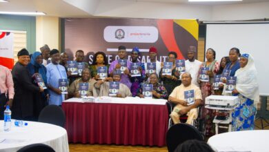 Group photo of disability advocates and government officials during report presentation.