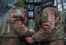 Military trucks involved in the transfer of fallen soldiers during wartime exchange