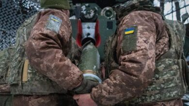 Military trucks involved in the transfer of fallen soldiers during wartime exchange